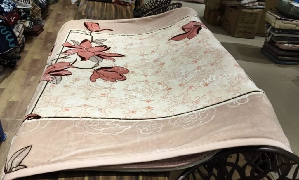 Pink floral mink blanket displayed in a showroom